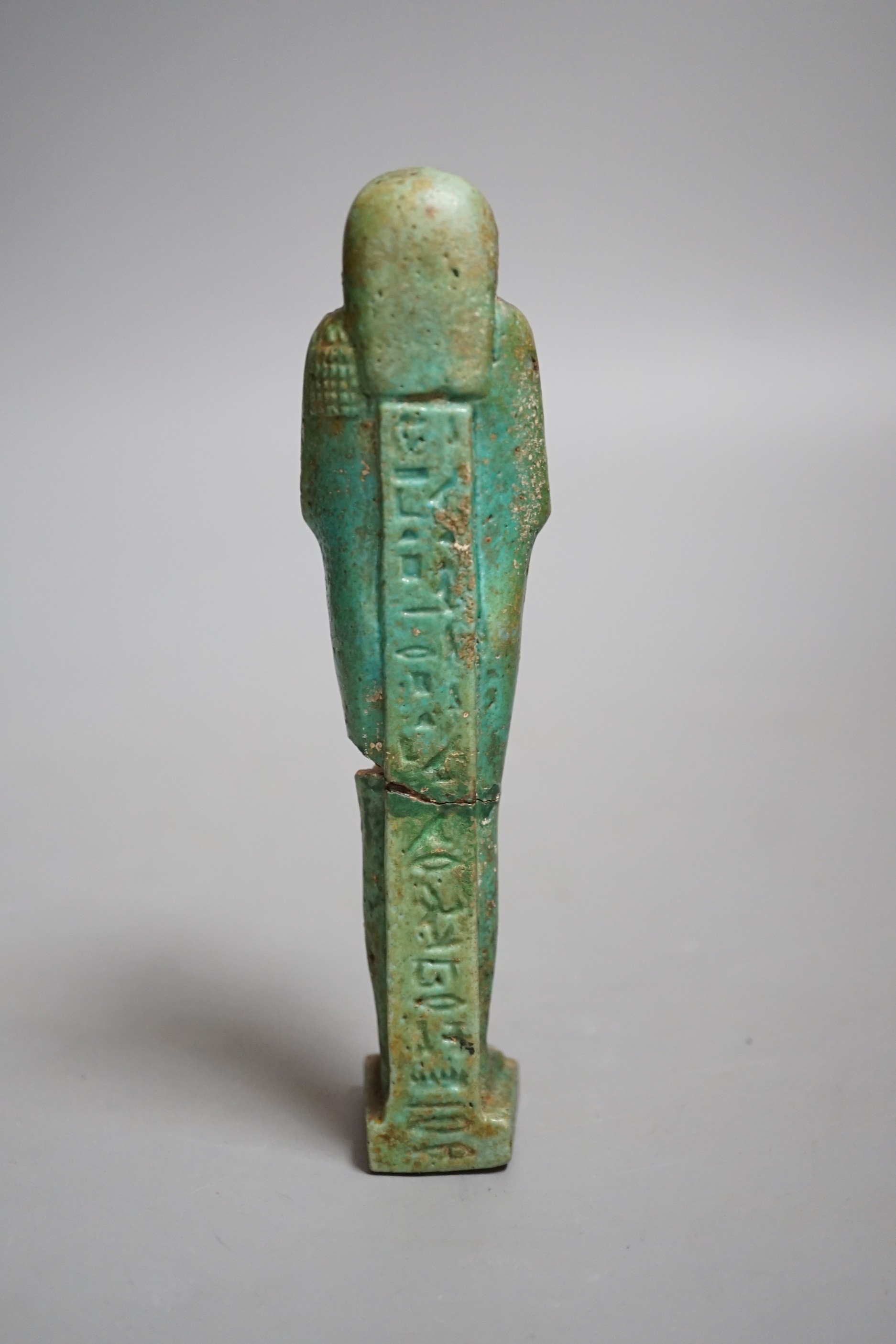 An Egyptian turquoise glazed faience ushabti, possibly Late Kingdom. 14.5cm